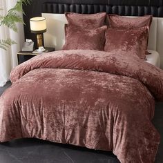 a bed with a brown comforter and pillows