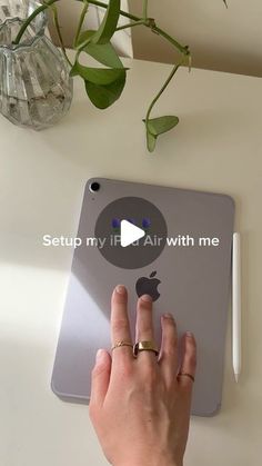 a person using an ipad on a table with a plant in the background and text that reads setup my air with me