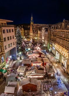 an aerial view of a city at night with christmas lights and decorations on the streets