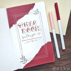 two pens sitting on top of a book next to an envelope with the title true book