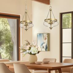 a dining room table with chairs and a vase filled with flowers