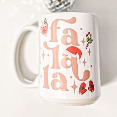 a coffee mug with the words fa la la on it