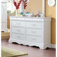 a white dresser and mirror in a room