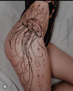 a woman's legs with an octopus tattoo on her leg and the bottom part of her thigh