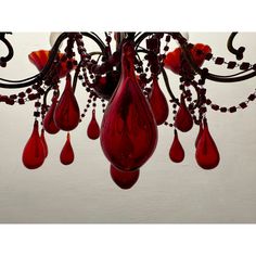 a chandelier with red glass drops hanging from it