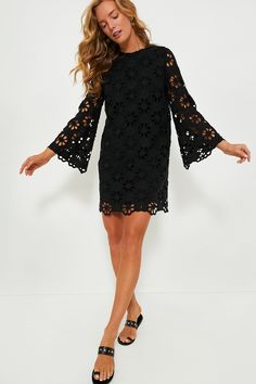 This best-selling silhouette is back in an updated look! The Noir Eyelet Hutton Dress is an elegant style perfect for date nights, dinner parties, and beyond. Featuring unlined floral lace bell sleeves, side slits for ease of movement, and an easy straight silhouette, this look can be styled hundreds of ways. Pair with heels and a clutch or ballet flats and a top-handle bag! Crewneck Long bell sleeves with scalloped edge Back zip closure Straight silhouette Side slits Midi length Lined body, unl Lace Bell Sleeves, Classic Dresses, Summer Style Guide, Cocktail Attire, Date Nights, Whale Tail, Weekend Wear, Classic Dress, Night Looks