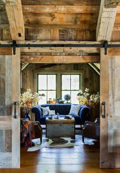 an open living room with sliding barn doors