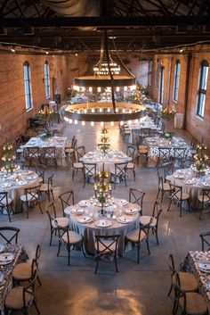 a large room with tables and chairs set up for an event or function in the center