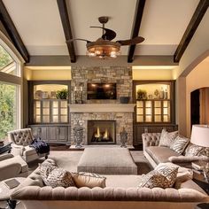 a living room filled with furniture and a fire place in the middle of a room