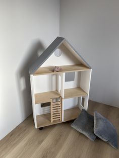 a doll house with furniture and accessories on the floor