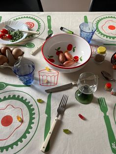 the table is covered with dishes and utensils