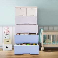 three boxes are stacked on top of each other in a child's nursery room