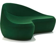 a green chair sitting on top of a white floor