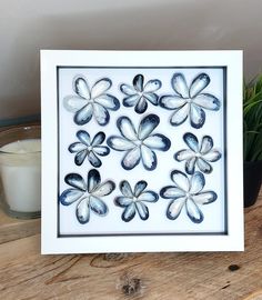 a card with blue and white flowers on it next to a potted green plant