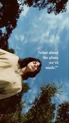 a woman standing in front of trees with a quote above her head