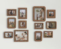 several wooden frames are arranged on the wall with family photos in them and one is holding a baby