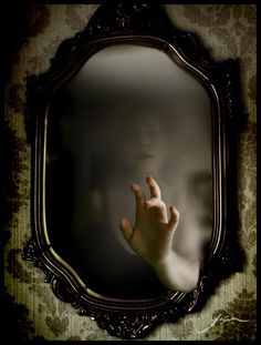 a person's hand in front of a mirror with the reflection of their hands