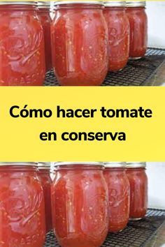 four jars filled with tomato sauce sitting on top of a rack