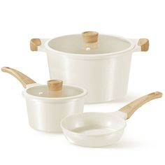 three white pots and two wooden spoons on a white background with clippings