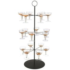 a wine glass holder with twelve glasses on it and a metal stand holding several champagne glasses