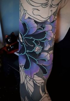 a woman's arm with flowers on it and an elephant in the middle of her arm