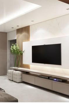 a large flat screen tv mounted to the side of a wall in a living room