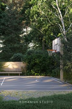 an empty basketball court surrounded by trees and bushes