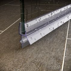 an image of rain drops falling on the glass door and floor in front of it