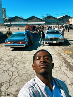 a man is standing in front of some cars