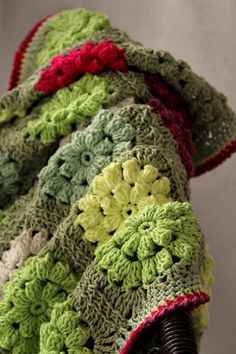 a crocheted blanket sitting on top of a chair