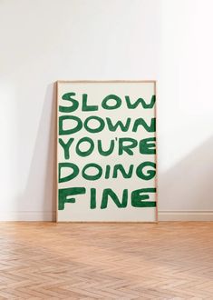 a green and white poster with the words slow down you're doing fine on it