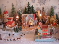 a christmas village with houses and people in it