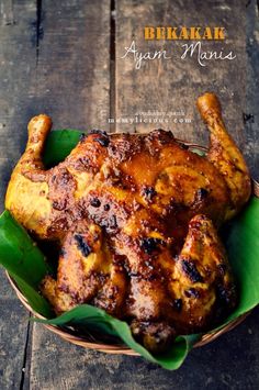 a close up of a chicken in a bowl on a wooden table with text above it