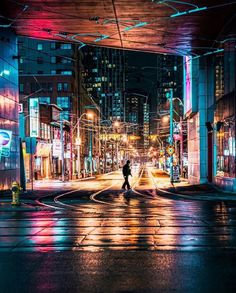 a man is crossing the street at night