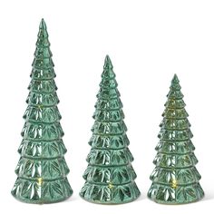 three green glass christmas trees sitting next to each other