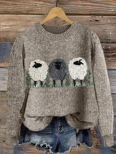 a sweater with two sheep on it