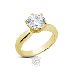 a yellow gold engagement ring with a round cut diamond in the center, on a white background