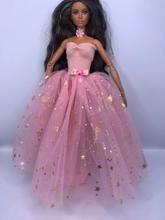 a barbie doll wearing a pink dress with stars on it