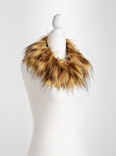 a white mannequin with a brown and black fur collar on it's neck