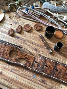 various items are sitting on a wooden table with beads and other crafting supplies around them