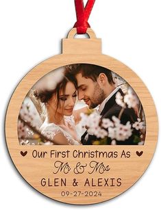 a wooden ornament with an image of a bride and groom