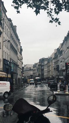 a motorcycle parked on the side of a wet street