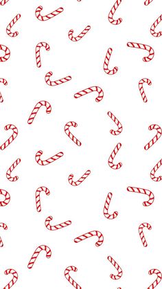 candy canes on a white background with red and white lines in the middle, all lined up