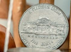 an old coin sitting on top of a wooden chair