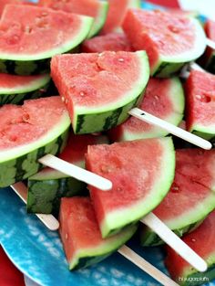 watermelon skewers with toothpicks on a blue plate