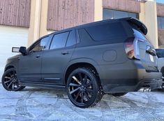 a grey suv parked in front of a building