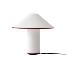 a white lamp with a red trim on it