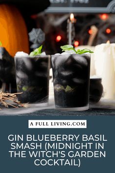 gin blueberry basil smash midnight in the witch's garden cocktail with pumpkins and candles