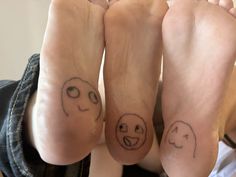 two people with faces drawn on their feet