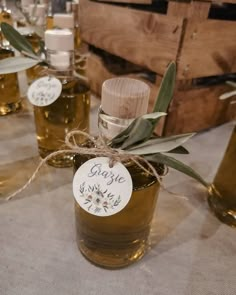 several jars filled with olive oil on top of a table